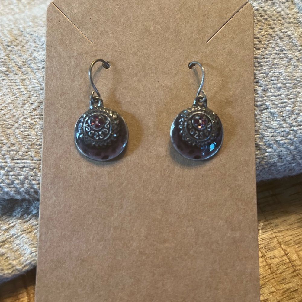 Intricate silver tone earrings